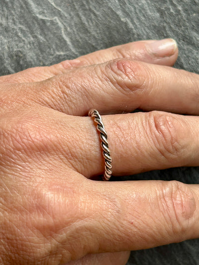 silver rope stacking ring shown on hand
