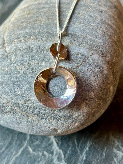 Sterling Silver Concave Pendant by LaVidaLoca Jewellery shown on a stone