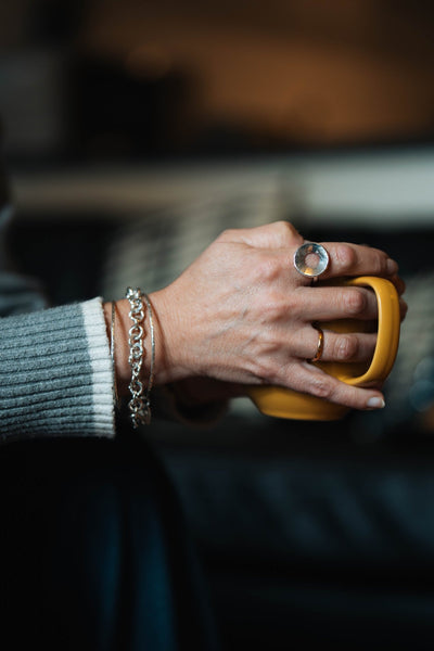 Sterling Silver Concave Ring by LaVidaLoca Jewellery shown on hand holding mug
