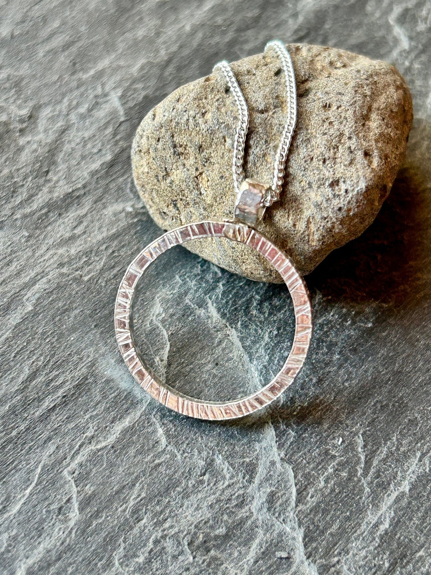 Sterling Silver Halo Pendant by LaVidaLoca Jewellery shown against stone