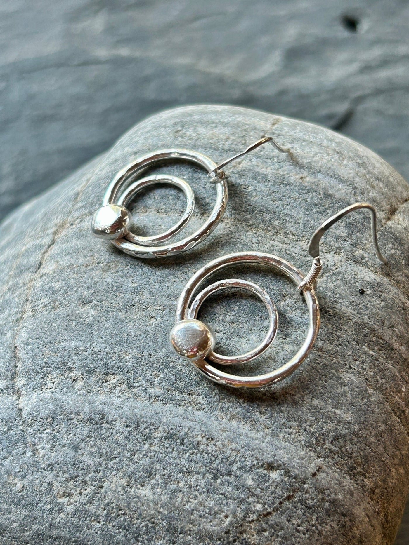 Sterling Silver Orbit Earrings by LaVidaLoca Jewellery shown on a stone