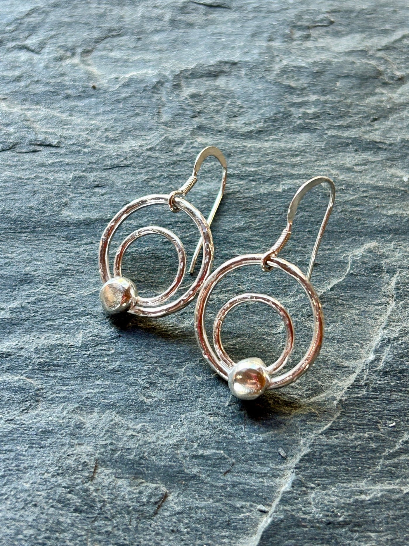 Sterling Silver Orbit Earrings by LaVidaLoca Jewellery on slate background