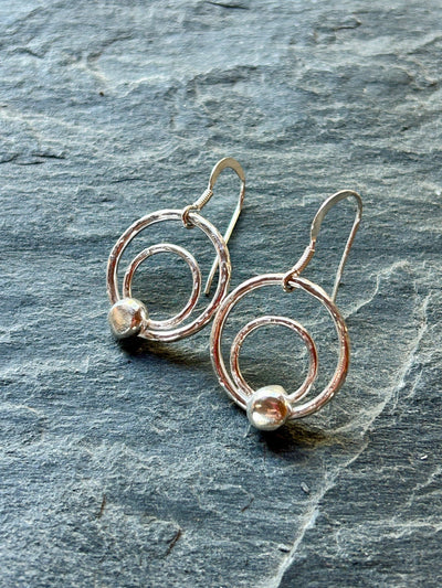 Sterling Silver Orbit Earrings by LaVidaLoca Jewellery on slate background
