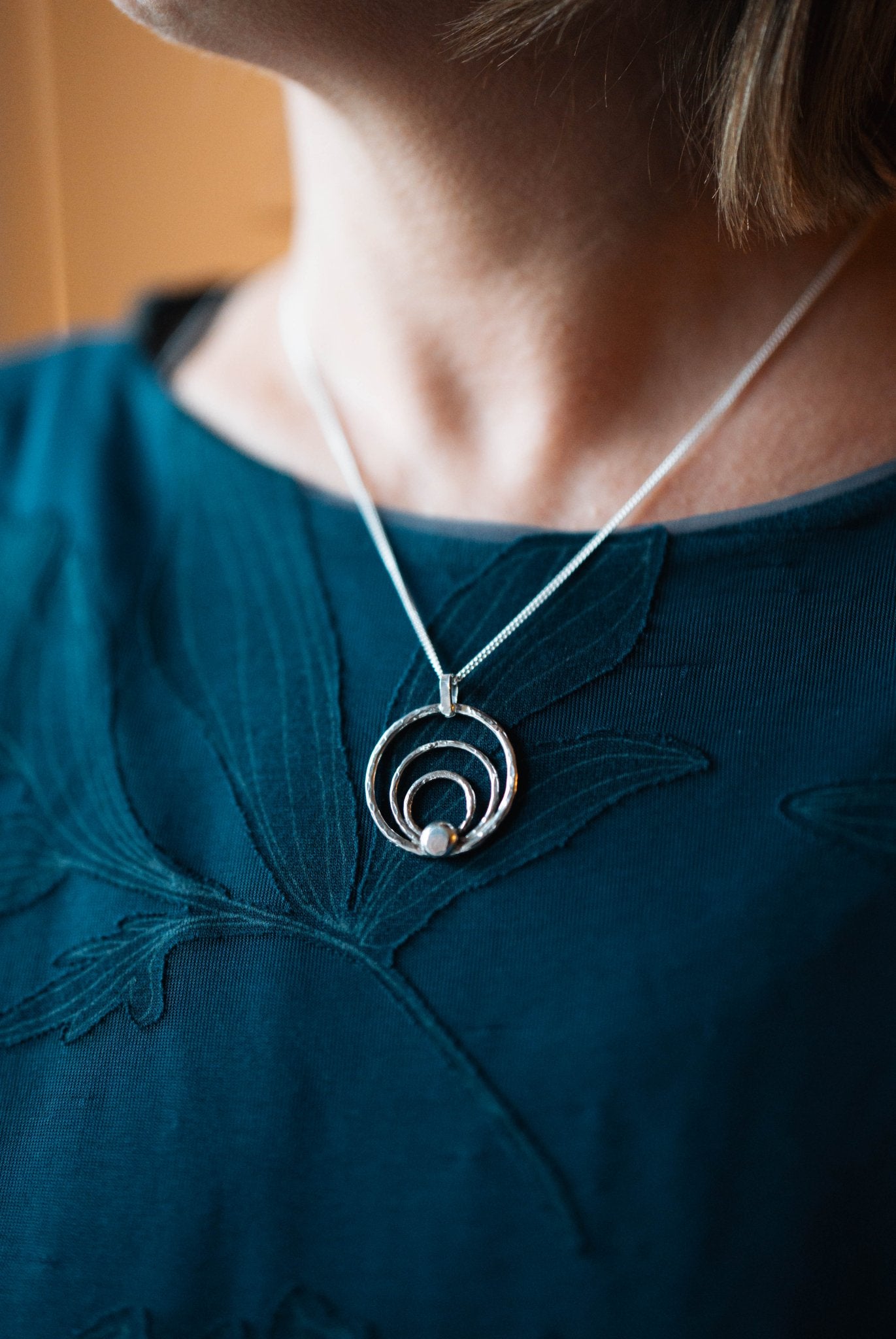Sterling Silver Orbit Pendant by LaVidaLoca Jewellery shown being worn