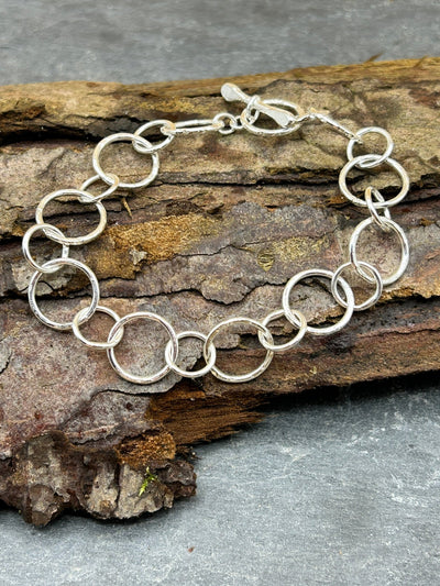 Sterling Silver handmade chain bracelet shown on a piece of bark