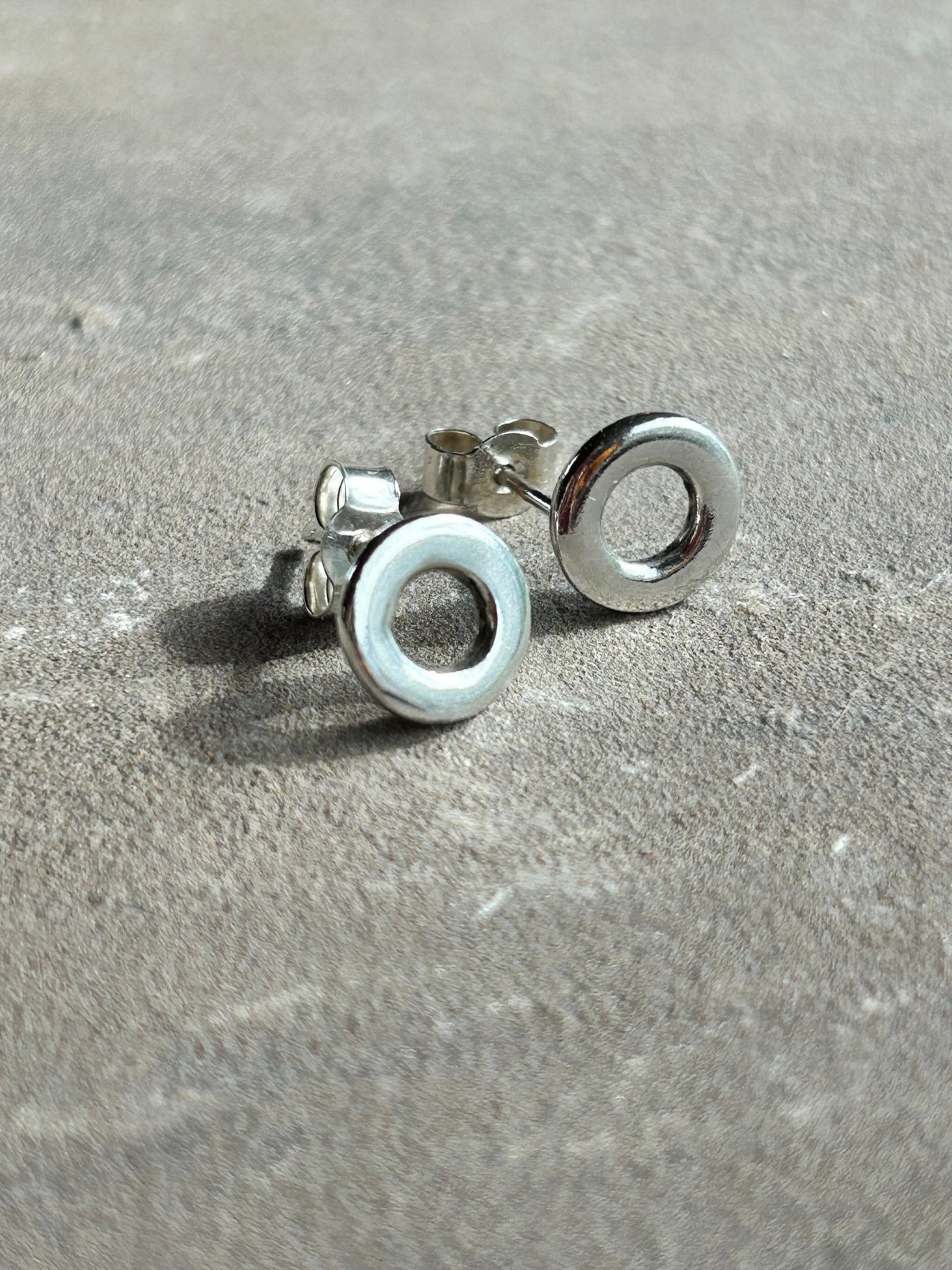 Sterling Silver Circle stud earrings by LaVidaLoca Jewellery shown on a slate