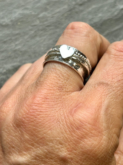 Sterling Silver Heart Spinner ring with three spinning bands shown on a hand
