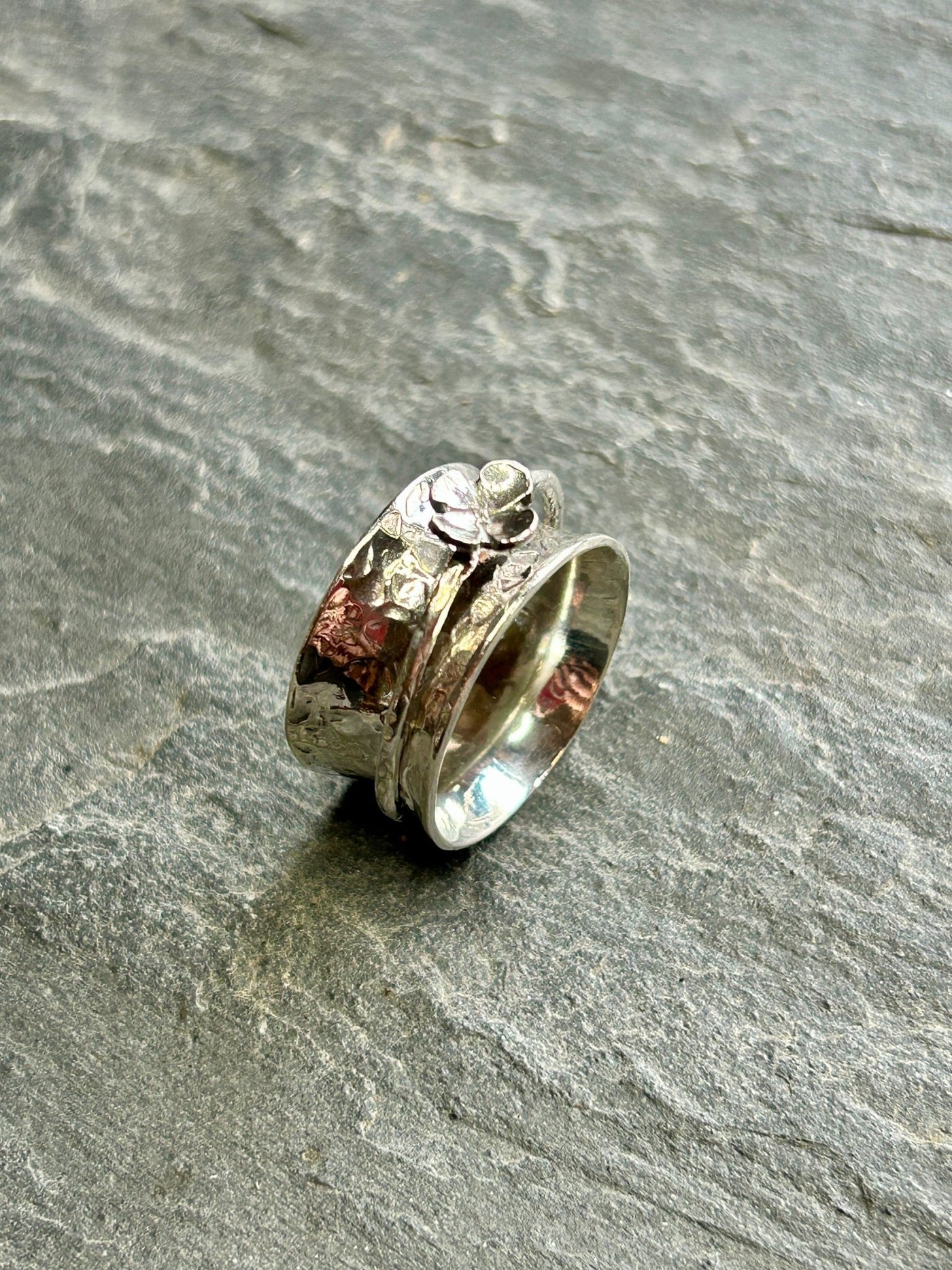 Sterling Silver Spinner ring with Four Leaf Clover Spinner shown on a grey slate background by LaVidaLoca Jewellery