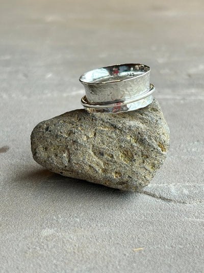 Sterling Silver Spinner ring with one wide silver spinner on a stone background - by LaVidaLoca Jewellery