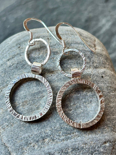 Textured Sterling Silver Halo Earrings by LaVidaLoca Jewellery shown on a stone