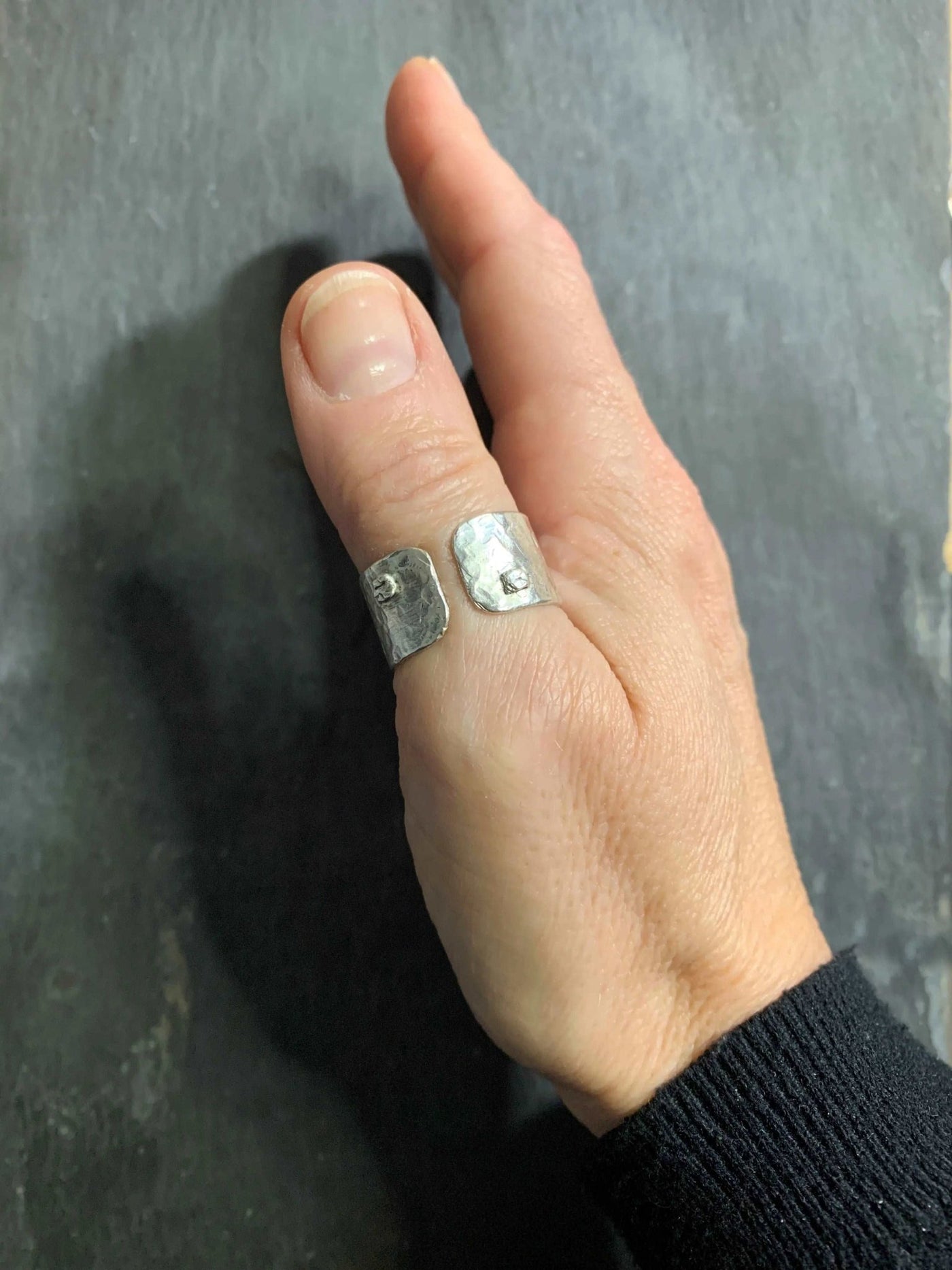 Wide adjustable silver ring shown on a thumb by LaVidaLoca Jewellery